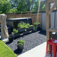 hot tub in the backyard of a residential property, sitting on ground stabilized by Ecoraster permeable pavers.