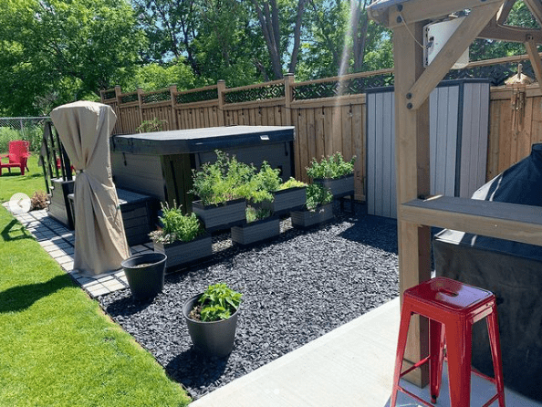 hot tub in the backyard of a residential property, sitting on ground stabilized by Ecoraster permeable pavers.