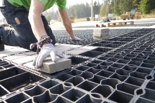 person completing a permeable paver installtion
