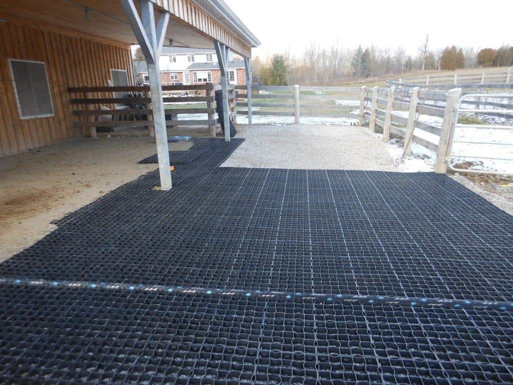 Ecoraster ground reinforcement grid installed to reduce mud and improve drainage in an agricultural area.