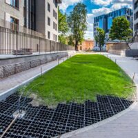 Ecoraster permeable paving grid installed with grass beside a walkway to improve drainage before winter