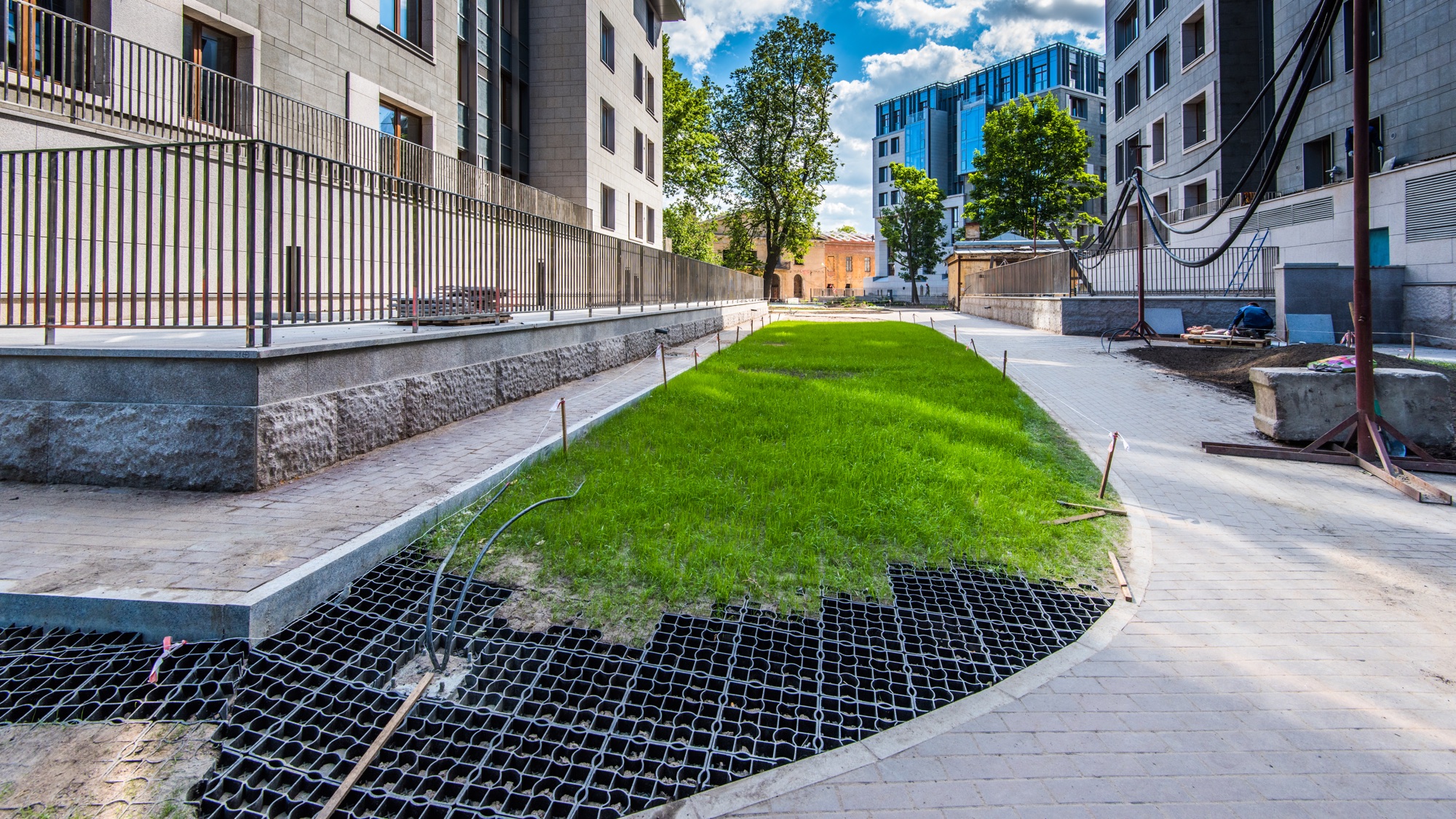 Ecoraster permeable paving grid installed with grass beside a walkway to improve drainage before winter