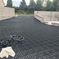ECORASTER permeable grid being installed across a residential driveway before fill.